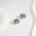 Detail view of fan-shaped stud earrings with blue cat-eye stone in silver metal - Blue