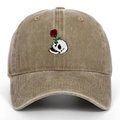 Close-up of skull and rose embroidery on khaki distressed cotton baseball cap - Khaki
