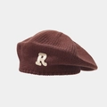 Close-up of thick knitted dark brown beret with white chenille R letter patch - Brown