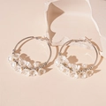 Detail of silver circle earrings with white acrylic flower charms on minimalist background - Flower Hoop Earrings / Silver/White