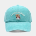 Macro view of light blue baseball cap featuring detailed bear embroidery and Lucky text - Adjustable / Lake Blue