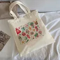 Cream canvas tote bag featuring colorful Christmas gingerbread and holiday illustrations - C12 Christmas Watercolor Elements