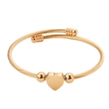 Golden heart charm cable wire bangle with minimalist twisted rope design and bead detail - Bangle / Gold