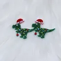 Christmas dinosaur earrings in green glitter acrylic with red Santa hat for holiday festive style - Christmas Dinosaur