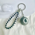 Detail of grey mini billiard ball number 6 keychain with black and white braided leather - No.6 (Grey/Light Blue)