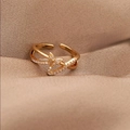 Close-up of golden butterfly open ring with sparkling crystal accents on fabric - Gold (D7324)