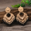 Vintage golden hollow heart earrings with black bead tassels on a dark wood background - Black