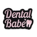 Cute enamel pin with Dental Babe text and pink tooth graphic on a black background - Dental Babe