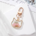 Charming cat-shaped dried flower keychain with pink daisies in a golden metal frame - Half Pink Daisy Cat
