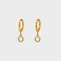 Detailed macro view of gold plated earrings featuring circular zircon micro-pave charms - Letter O
