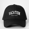 Detail of black cotton baseball cap featuring white VACATION text and vintage typography - One Size / Black