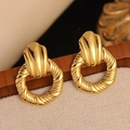 Detail view of retro gold stainless steel earrings with textured circular pattern - Vintage Spiral Openwork Round Earrings