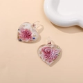 Macro detail of heart-shaped glass charms with pink floral patterns and gold foil flakes - Pink (Type A)
