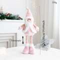 Detail of pink sequin Santa doll with telescopic legs on a festive white table - Pink Telescopic Santa Claus