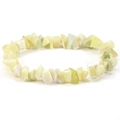 Close-up of irregular natural stones on a stretch bracelet with green and beige tones - Lemon Jade