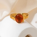Detailed close-up of retro gold titanium ring with oval amber stone on silk backdrop - Amber Oval Cabochon Style (TYR0845)