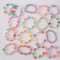 Colorful Y2K beaded bracelets set with floral charms and heart shapes on white background - Red Cord Fortune Bracelet / Red
