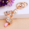 Golden perfume bottle and lipstick keychain with sparkling crystals and a faux pearl charm - Pink Perfume & Lipstick