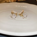 Macro detail of gold flower earrings with crystals on a textured ceramic surface - 19# Silver Needle-Gold-Zircon Flower