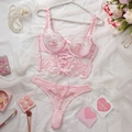 Elegant pink lace lingerie set with floral embroidery and ribbon corset on white tulle - Pink