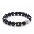 Black onyx beaded bracelet featuring 10mm white turquoise and golden letter X charm - Letter X