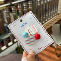 Detail view of colorful acrylic hair clips with stripes and solid polka dots on card - Two-Piece Set / Red Blue Bead Slant Stripe Clip
