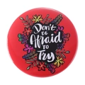 Red circular tinplate badge with colorful floral motifs and 'Don't BE Afraid TO Try' text - Dont BE Afraid TO Try
