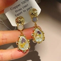 Vintage style 18K matte gold plated copper earrings with colorful dried flowers in resin - Light Blue Water Drop Dried Flower