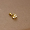 Close-up of gold stainless steel cartilage stud earring with three white zircons - Triple Zirconia Cluster / Gold
