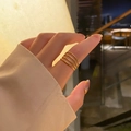 Set of 4 minimalist vintage gold beaded and rope twist adjustable rings on model's hand - KTG031J-Beaded And Twist Stacking Combo