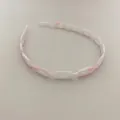 Detail of pink and white marble acetate chain-link headband with a minimalist aesthetic - Pink