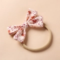 Detail of floral bow headband with orange blossoms and stretchy nylon elastic band - Pink Base Brown Flower Abstract