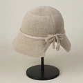 Detail of knitted bucket hat with a stylish bowknot on breathable mesh material - M (56-59cm) / Beige