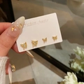Golden bow stud earrings set with white crystals on a 925 silver needle base - A2201 Gold