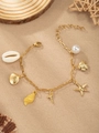 Golden ocean theme bracelet with pearls, starfish and seashell charms on a sandy base - Letter T(T)
