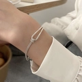 Minimalist silver chain bracelet with polished U-shaped buckle and woven texture detail - Heart Knot Intertwined Bracelet