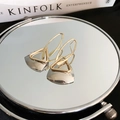 Macro detail of gold geometric triangle earrings resting on a mirror with magazine - Silver Needle (1 Pair) / Two-tone Gold Silver