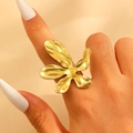 Exaggerated golden flower leaf ring with polished finish on model's finger - Gold (0519)