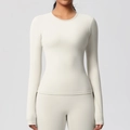 Close-up of slim fit round neck yoga long sleeve top in cream white sporty fabric - Light Ivory