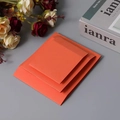 Three orange cardstock sleeves for floating PE film jewelry boxes stacked on gray background - 9x9x2cm / Orange Cardboard Sleeve