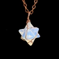 Macro shot of handcrafted copper wire-wrapped white opal Merkaba star pendant - Antique Copper + Opalite