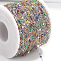 Macro detail of multicolored enamel beads on a stainless steel chain for DIY jewelry making - Steel Chain Multicolor Beads