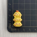 Macro shot of resin yellow chick charms showing exact dimensions on a ruler scale - Stacked Triple Chickens