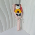 Detail of graduation bear plush and sunflower bouquet wrapped in pink gift paper - Light Pink + Sunflower