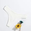 White ribbed cotton thong for women with a minimalist seamless knit texture on white background - L (30) / White