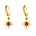 Macro detail of gold star earrings with ruby red zircon stone and huggie closure - Red