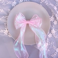 Close-up of pink iridescent tulle bow hairclip on a decorative plate with soft lighting - 1240 Iridescent Pink