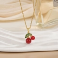 Elegant gold cherry pendant necklace with red fruit and green crystal leaves on a chain - Red Bead Cherry Style (XL0585)