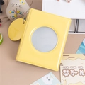 Close-up of bright yellow 3-inch photo album with circular window and metal bead chain - Yellow Round