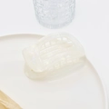Close-up of pearl white acetate hair claw clip with arched design on a tray - 13# White Mermaid PVC Claw